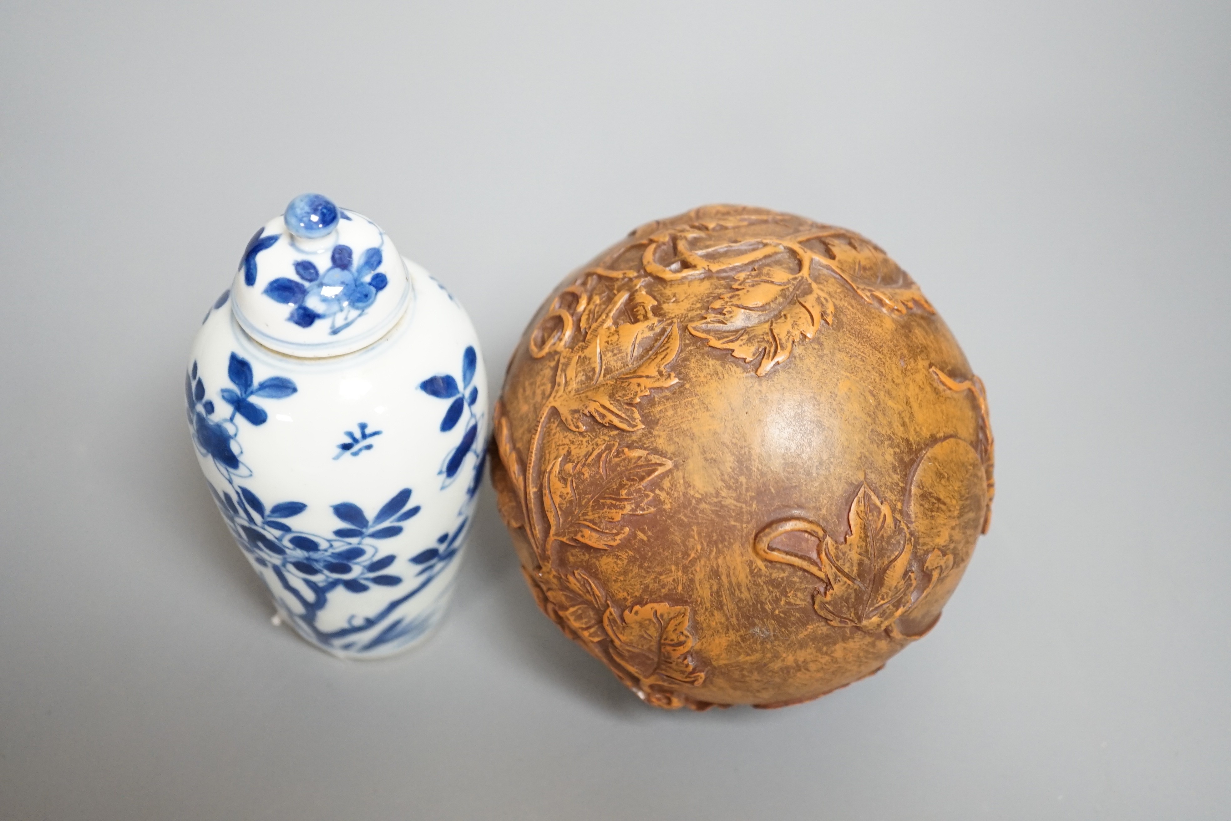 A Chinese blue and white jar and cover, Kangxi period, height 12cm and a Chinese ball